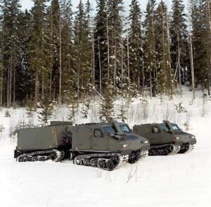 Bv206S APC vehicles in a snowy setting